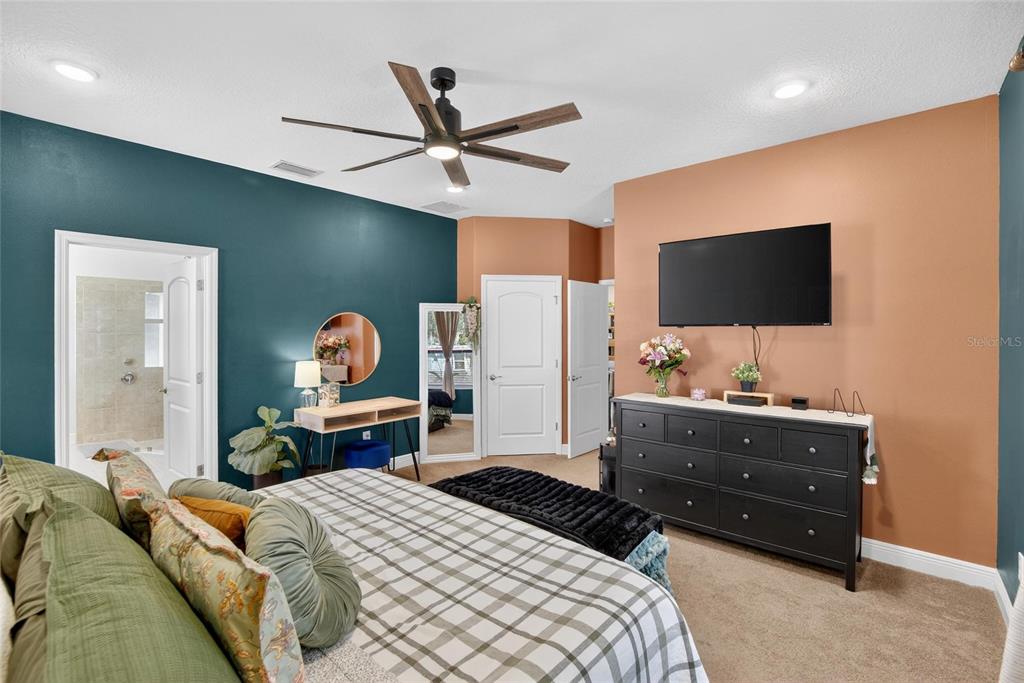 11439 Crowne Pointe Street New Port Richey, FL 34654 - Photo 32 of 50 a bedroom with a bed and a flat screen tv