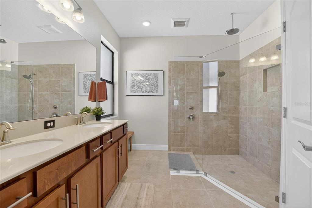 11439 Crowne Pointe Street New Port Richey, FL 34654 - Photo 34 of 50 a bathroom with a double vanity sink mirror and shower