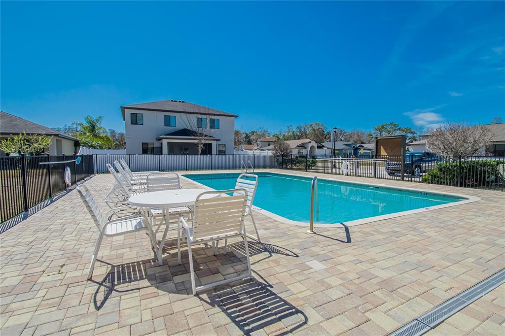 11439 Crowne Pointe Street New Port Richey, FL 34654 - Photo 45 of 50 a swimming pool with outdoor seating and yard