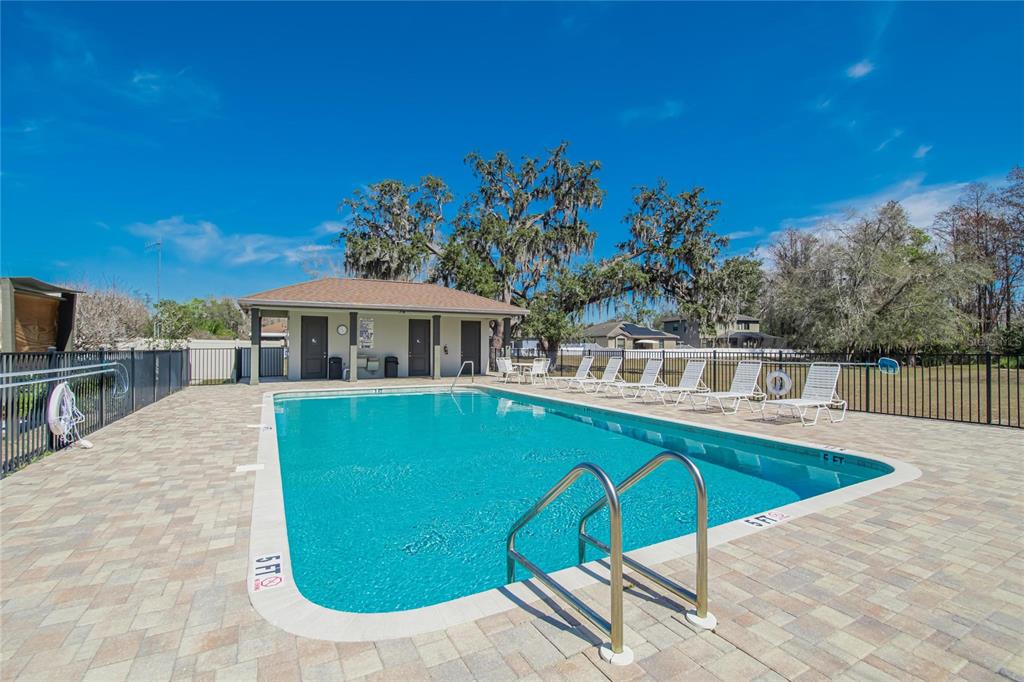 11439 Crowne Pointe Street New Port Richey, FL 34654 - Photo 46 of 50 a view of a house with swimming pool