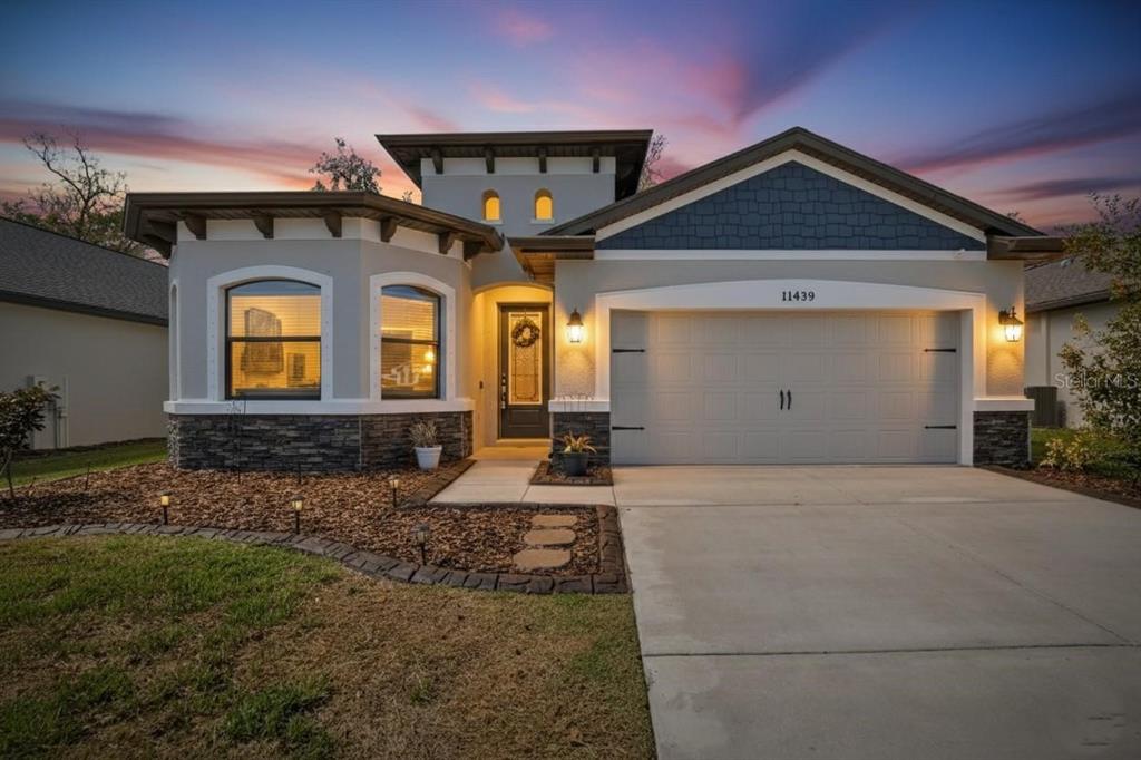 11439 Crowne Pointe Street New Port Richey, FL 34654 - Photo 50 of 50 a front view of a house with large windows