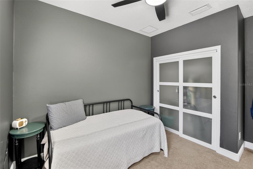 11439 Crowne Pointe Street New Port Richey, FL 34654 - Photo 10 of 50 a bedroom with a bed and a window