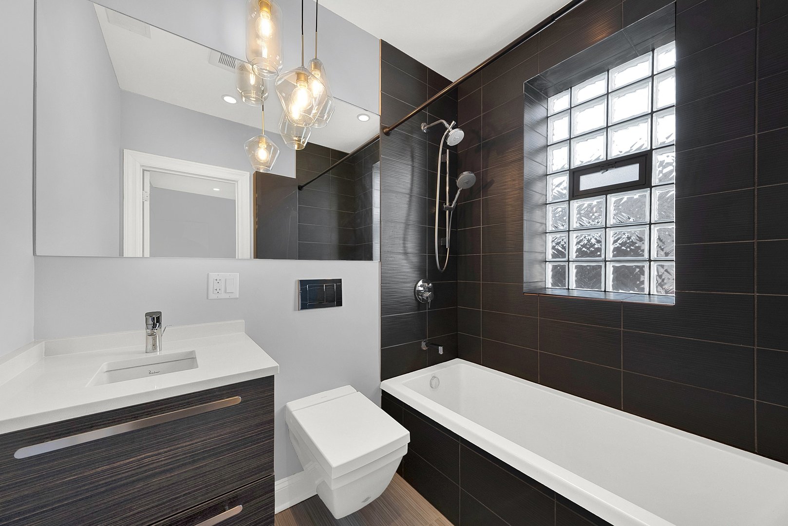 Undisclosed Address Chicago, IL 60647 - Photo 6 of 10 a bathroom with a sink a toilet a mirror and shower