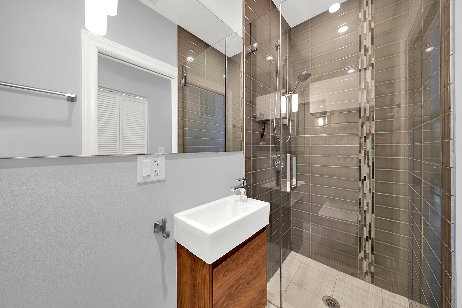 Undisclosed Address Chicago, IL 60647 - Photo 8 of 10 a bathroom with a sink a toilet a mirror and shower