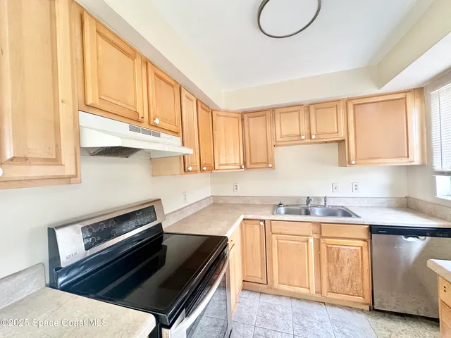 a kitchen with stainless steel appliances granite countertop a sink a stove and a microwave