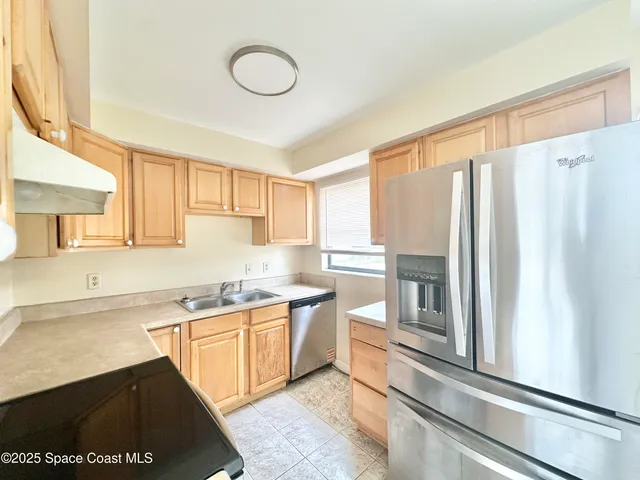 a kitchen with stainless steel appliances a sink stove and cabinets