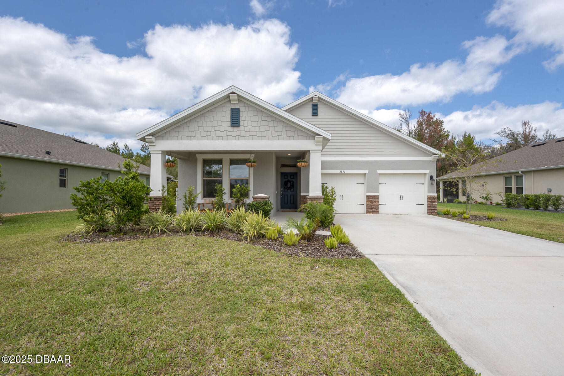 2853 Monaghan Drive Ormond Beach, FL 32174 - Photo 1 of 47 a front view of a house with a yard