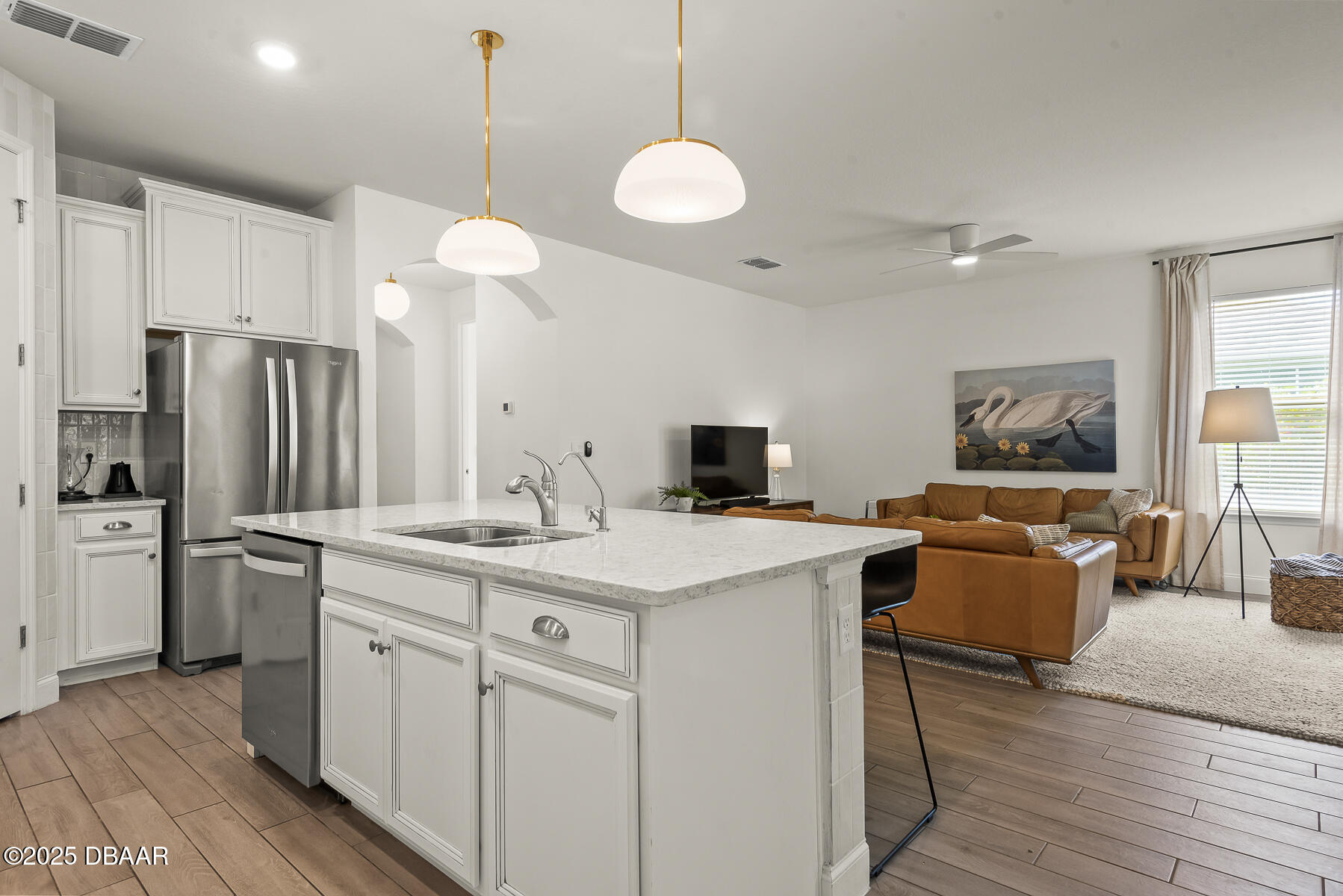 2853 Monaghan Drive Ormond Beach, FL 32174 - Photo 11 of 47 a kitchen with kitchen island a white counter top space stainless steel appliances and wooden floor