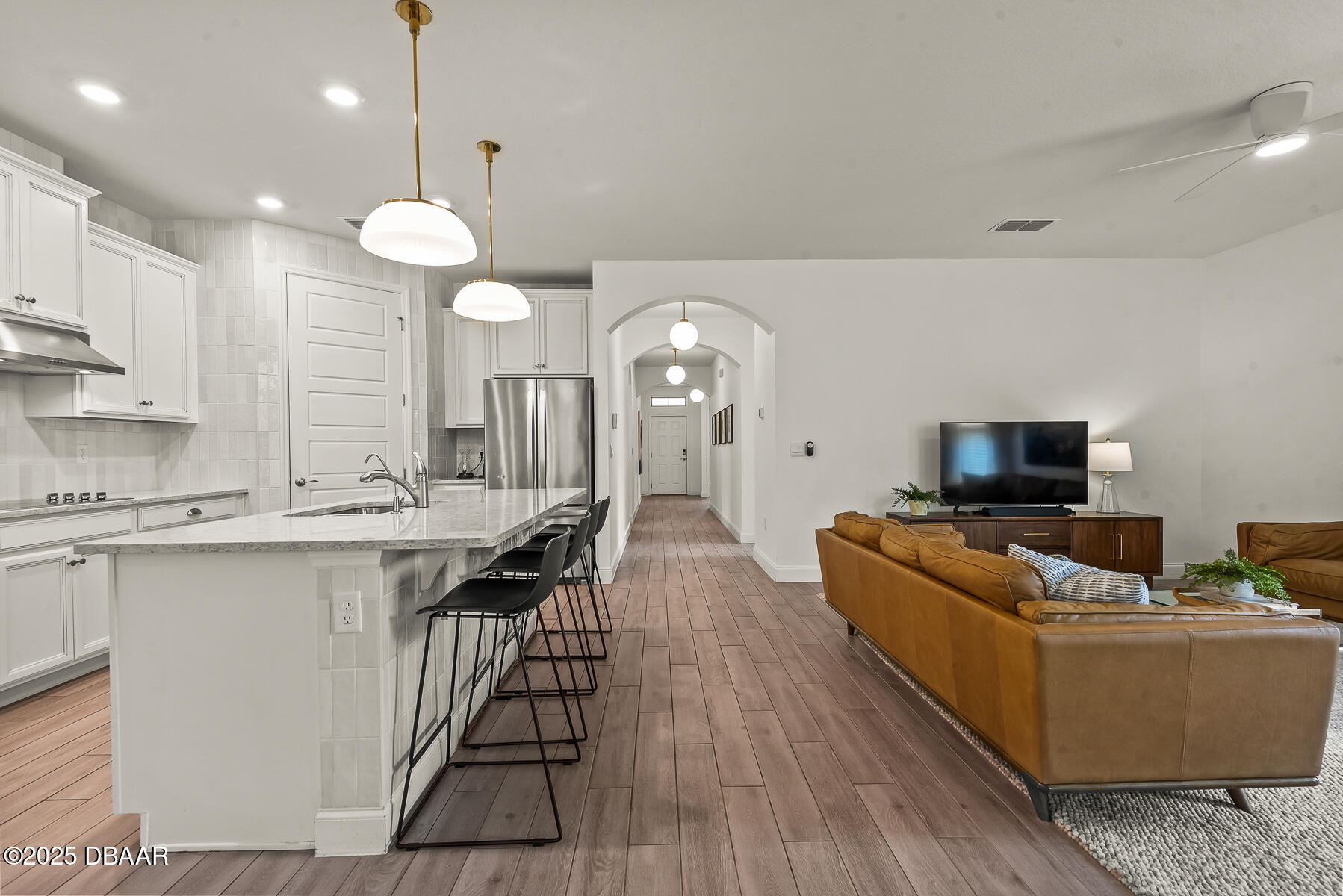 2853 Monaghan Drive Ormond Beach, FL 32174 - Photo 15 of 47 a living room with furniture a flat screen tv and kitchen view