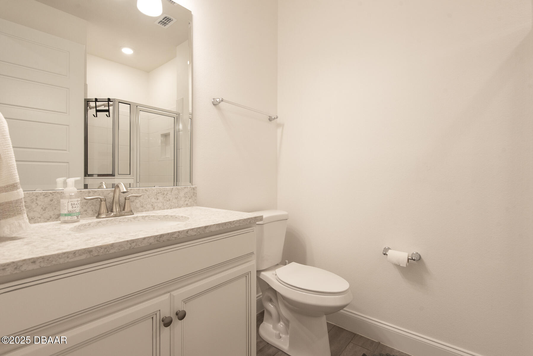 2853 Monaghan Drive Ormond Beach, FL 32174 - Photo 22 of 47 a bathroom with a granite countertop sink a toilet and a mirror