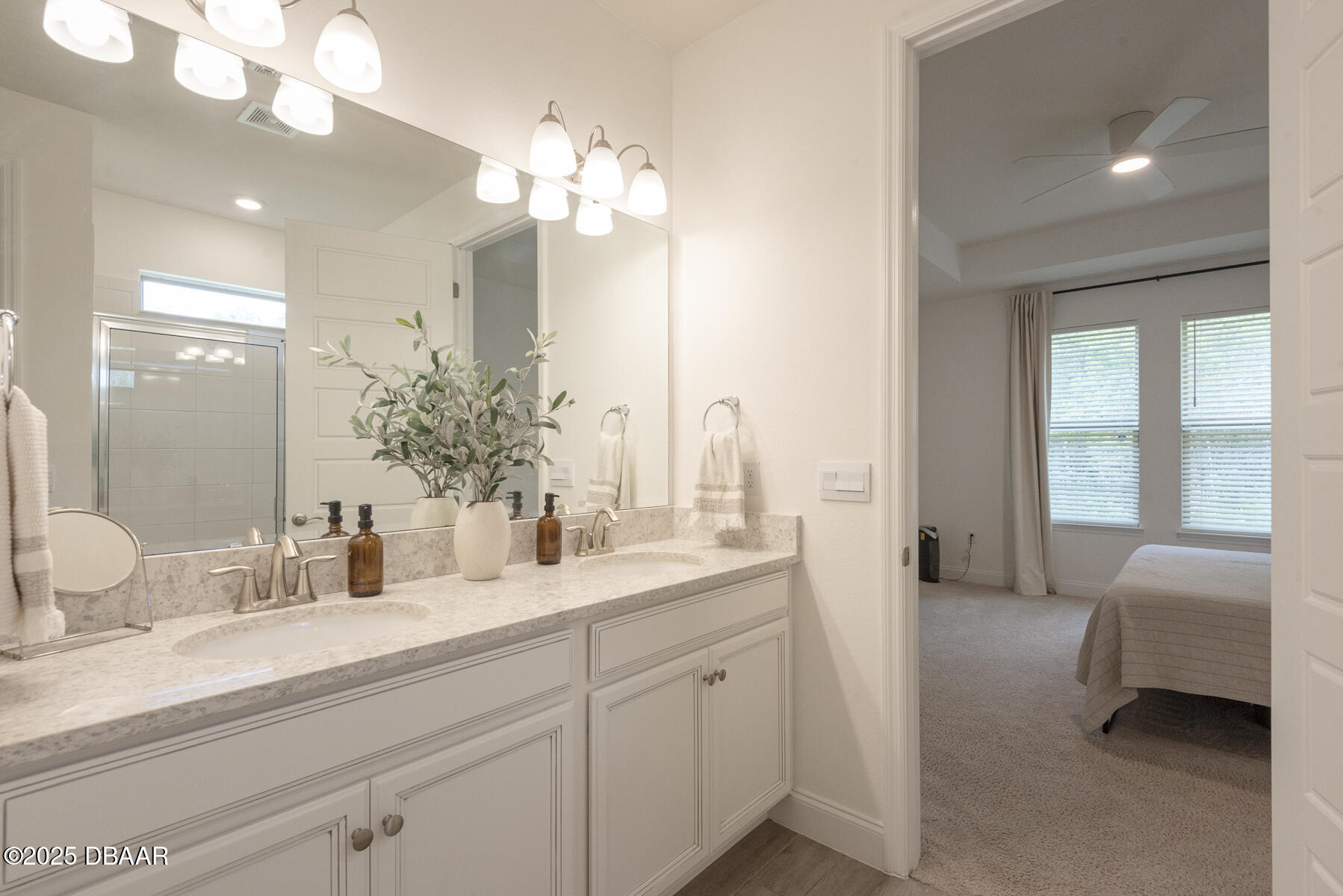 2853 Monaghan Drive Ormond Beach, FL 32174 - Photo 39 of 47 a en suite bathroom with double vanity a mirror and a lamp