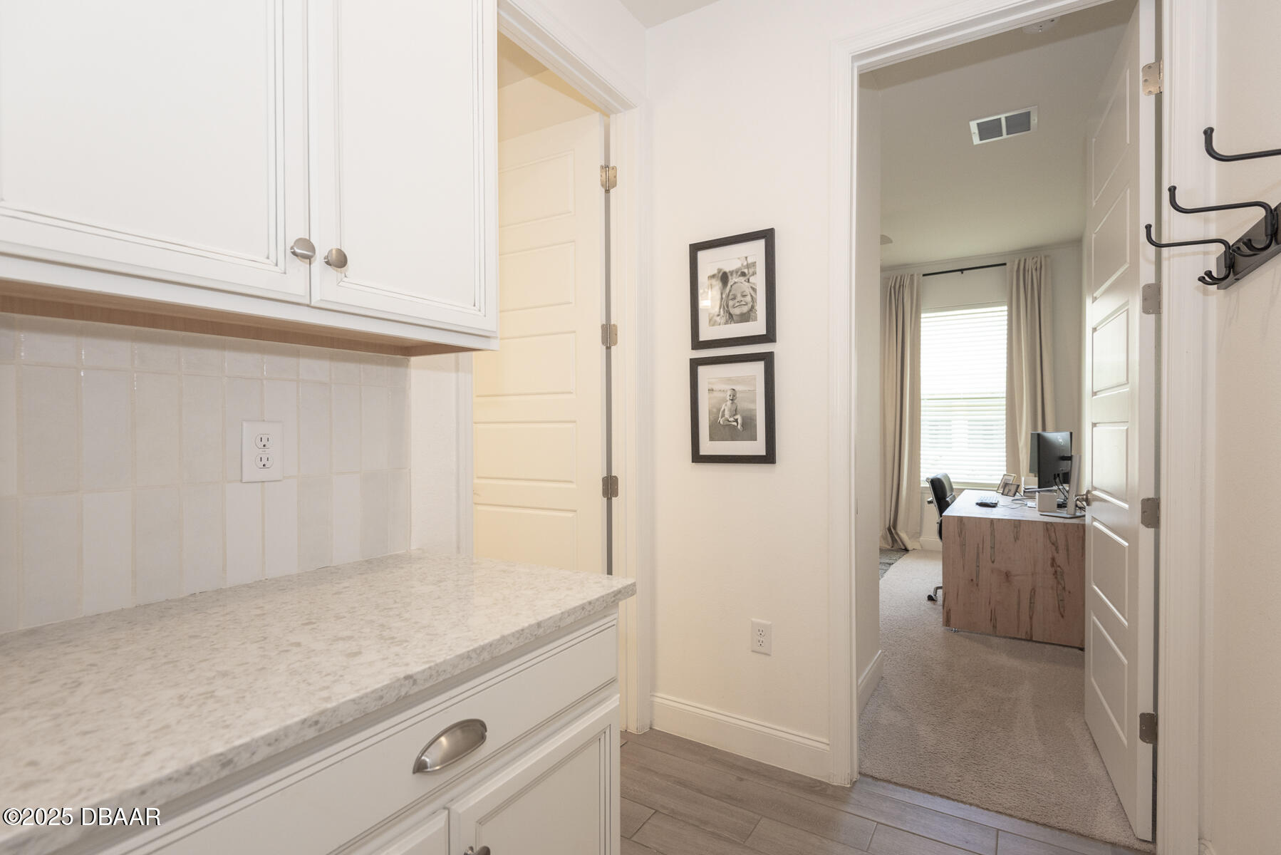 2853 Monaghan Drive Ormond Beach, FL 32174 - Photo 42 of 47 a hallway with white cabinets and wooden floor
