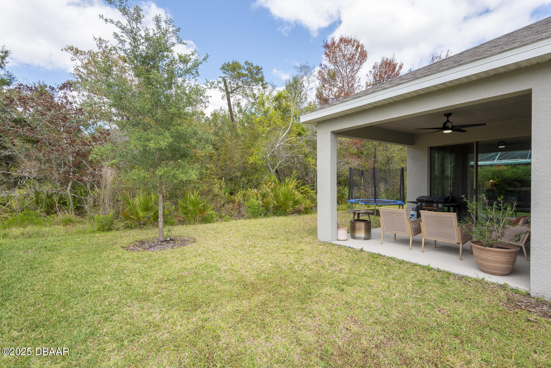 2853 Monaghan Drive Ormond Beach, FL 32174 - Photo 44 of 47 a view of a patio with table and chairs and potted plants