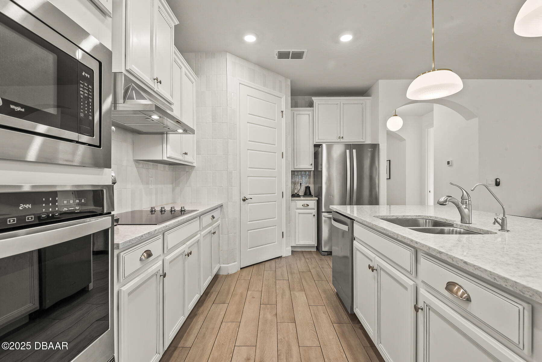 2853 Monaghan Drive Ormond Beach, FL 32174 - Photo 9 of 47 a kitchen with stainless steel appliances sink stove refrigerator and cabinets