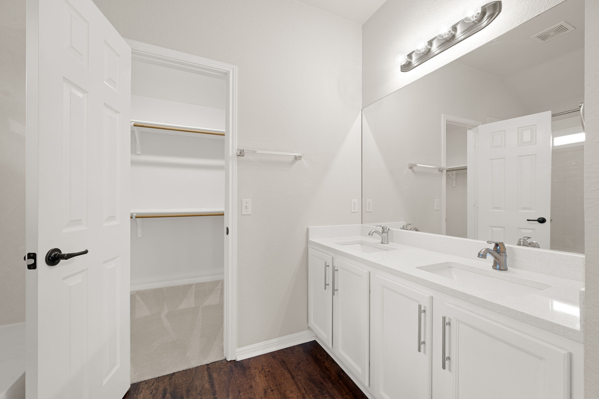 8902 Magna Carta Loop, Unit 122 Austin, TX 78754 - Photo 18 of 39 A well-appointed bath features a double vanity and an adjacent walk-in closet.