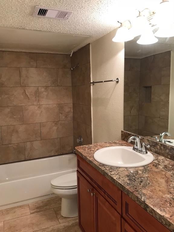 1947 Greenbriar Colony Drive, Unit 15518F Houston, TX 77032 - Photo 5 of 12 a bathroom with a granite countertop sink toilet and shower