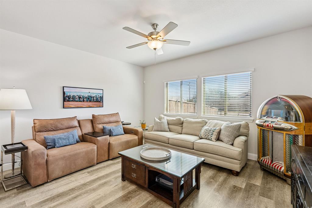 3236 Patrick Street Wylie, TX 75098 - Photo 11 of 35 a living room with furniture a couch and a chandelier