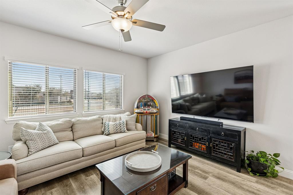 3236 Patrick Street Wylie, TX 75098 - Photo 13 of 35 a living room with furniture a flat screen tv and a fireplace