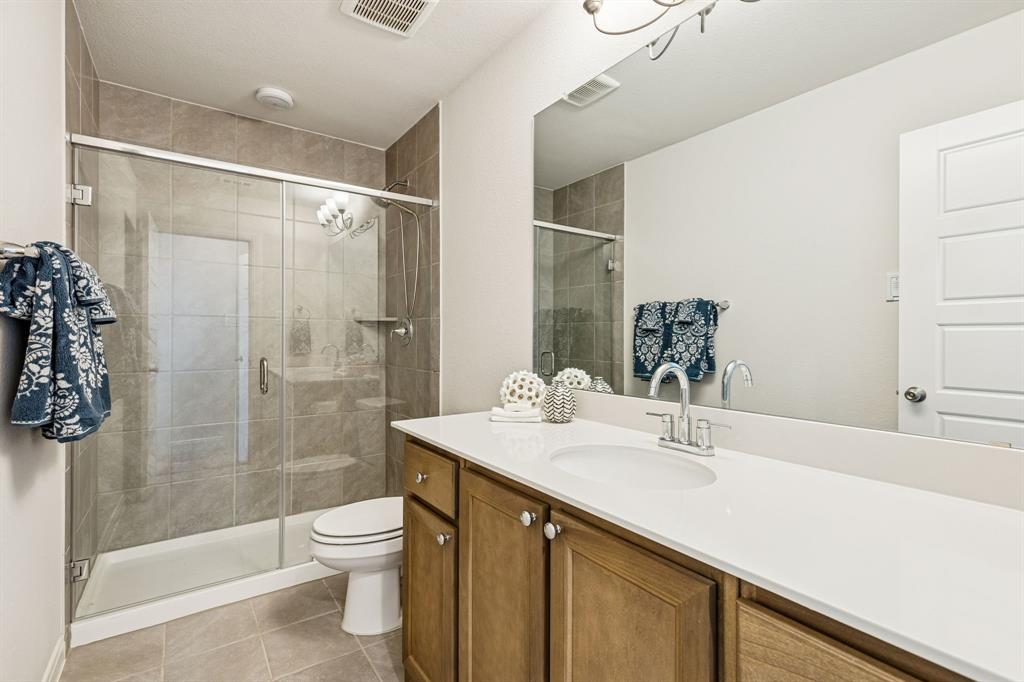 3236 Patrick Street Wylie, TX 75098 - Photo 18 of 35 a bathroom with a sink a toilet and shower