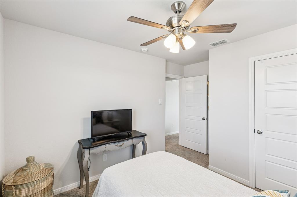 3236 Patrick Street Wylie, TX 75098 - Photo 25 of 35 a bedroom with a bed and a flat screen tv