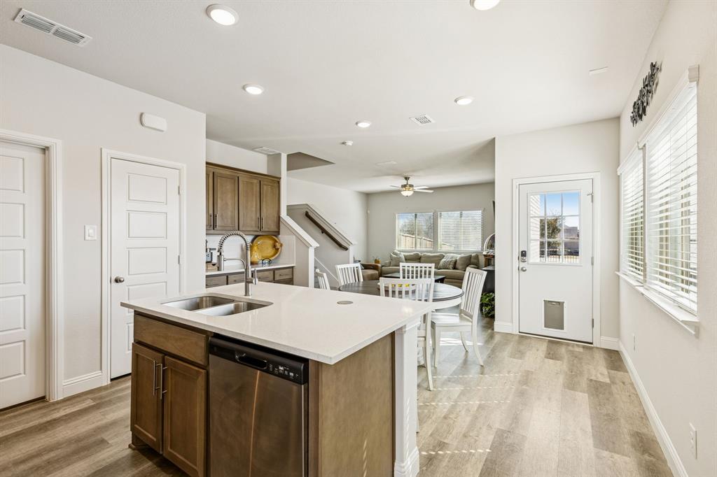 3236 Patrick Street Wylie, TX 75098 - Photo 5 of 35 a kitchen with a sink a stove and chairs