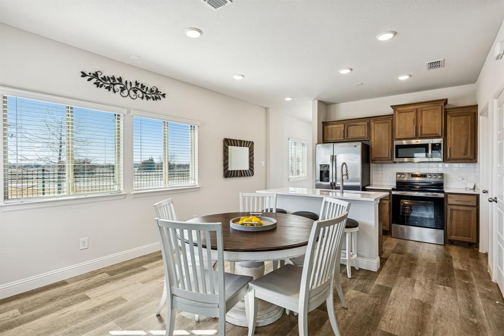 3236 Patrick Street Wylie, TX 75098 - Photo 7 of 35 a view of a dining room with furniture a rug and wooden floor