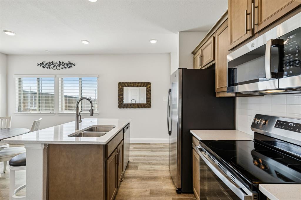 3236 Patrick Street Wylie, TX 75098 - Photo 9 of 35 a kitchen with stainless steel appliances granite countertop a sink and a stove