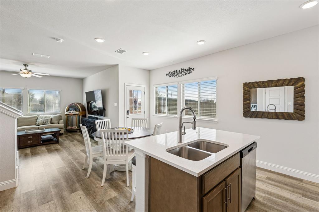3236 Patrick Street Wylie, TX 75098 - Photo 10 of 35 a kitchen that has a sink a table and chairs in it