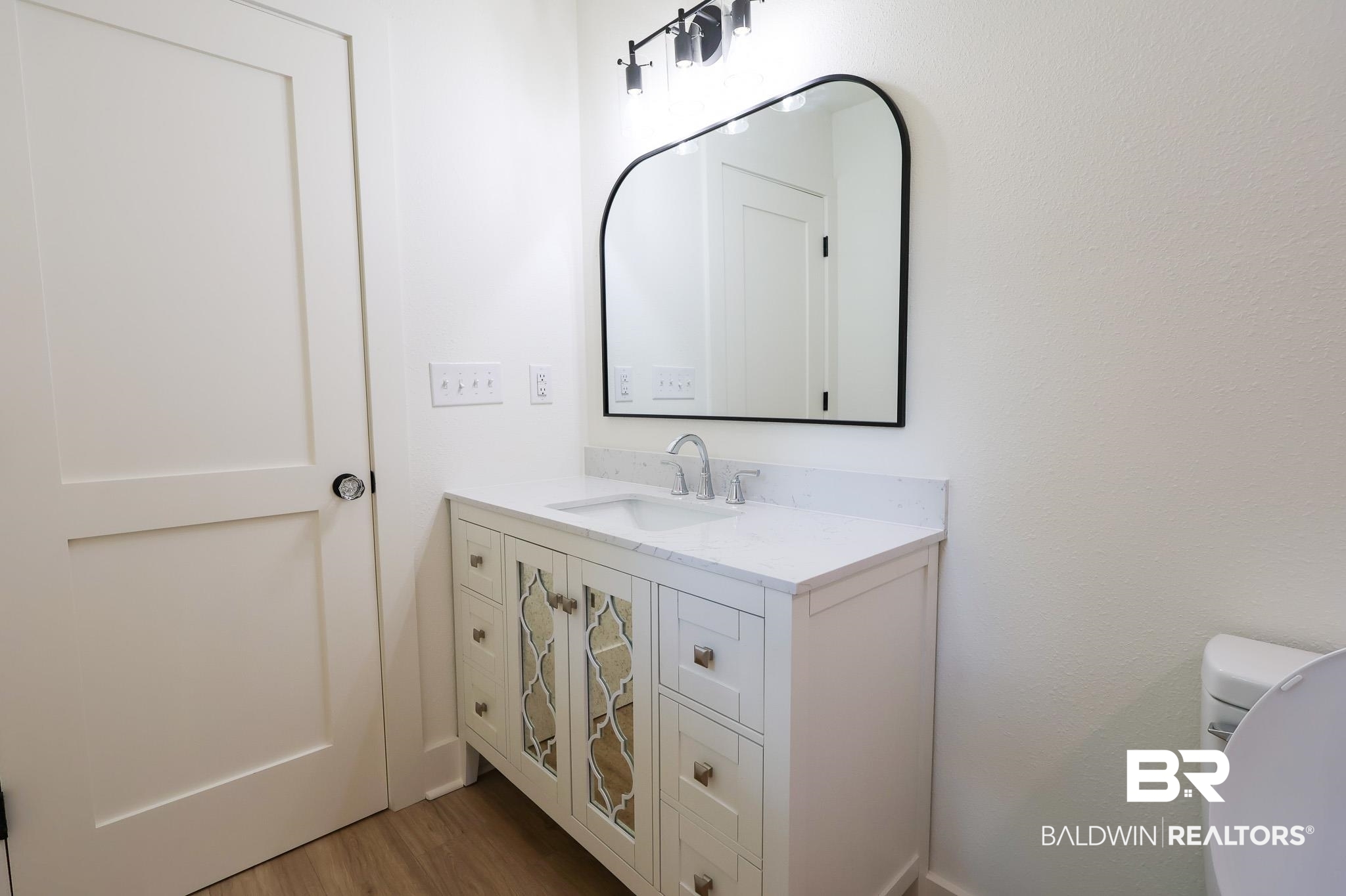 12190 Pecan Grove Street Magnolia Springs, AL 36555 - Photo 28 of 45 Bathroom featuring vanity, hardwood / wood-style flooring, and toilet