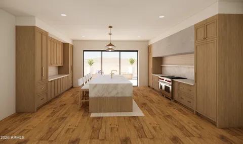 a large kitchen with kitchen island a large counter space a sink appliances and cabinets