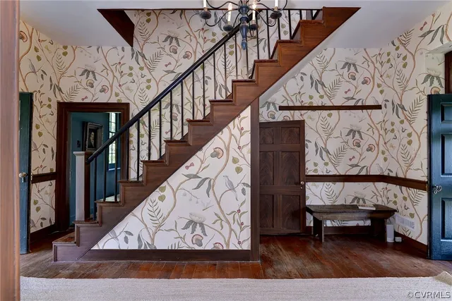 a view of entryway and hall with wooden floor