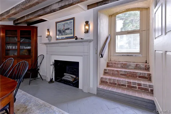a kitchen with stainless steel appliances wooden floor stove top oven and cabinets