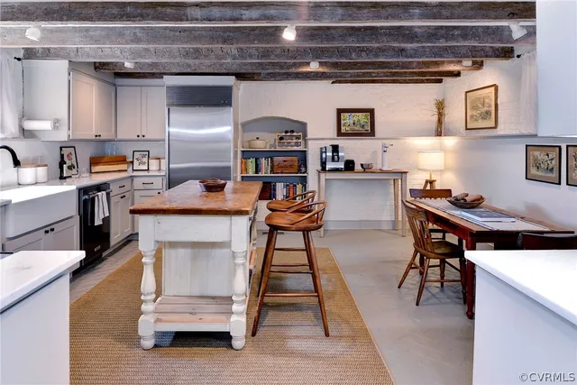 a view of a kitchen with a table and chairs