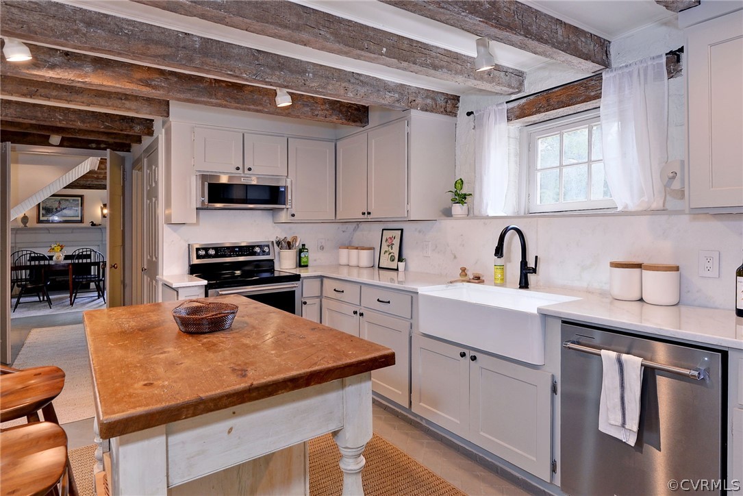 2459 Dunbrooke Road Tappahannock, VA 22560 - Photo 28 of 49 a kitchen with a sink a stove and cabinets