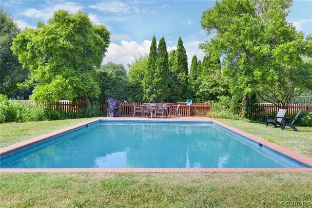 a view of a swimming pool with a yard