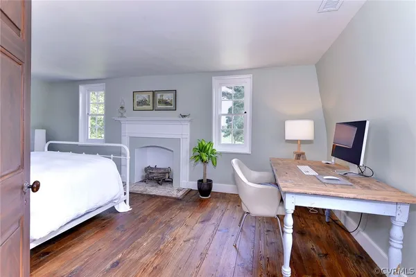 a living room with furniture a flat screen tv and a floor to ceiling window