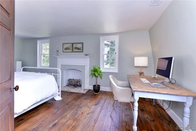 a living room with furniture a flat screen tv and a floor to ceiling window