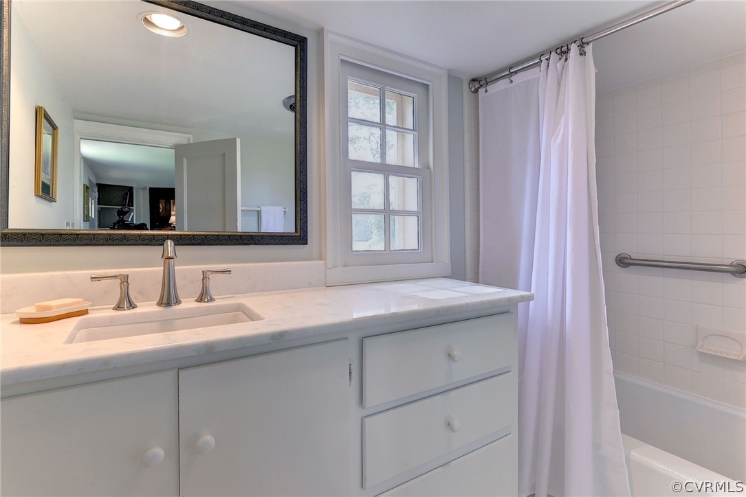 2459 Dunbrooke Road Tappahannock, VA 22560 - Photo 36 of 49 a bathroom with a granite countertop sink a mirror and a bathtub