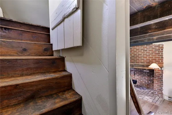 a view of a house with a big yard and large tree