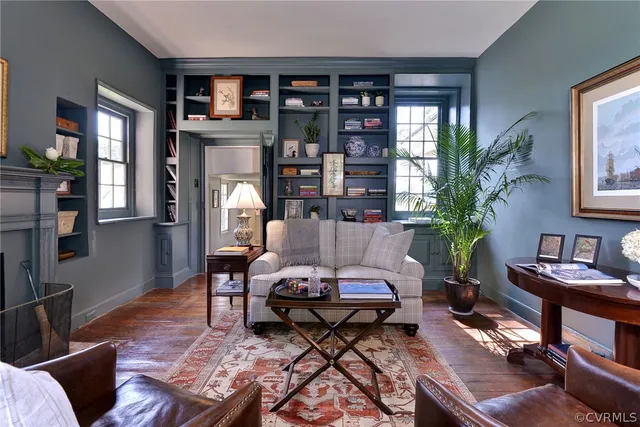 a living room with furniture and a potted plant