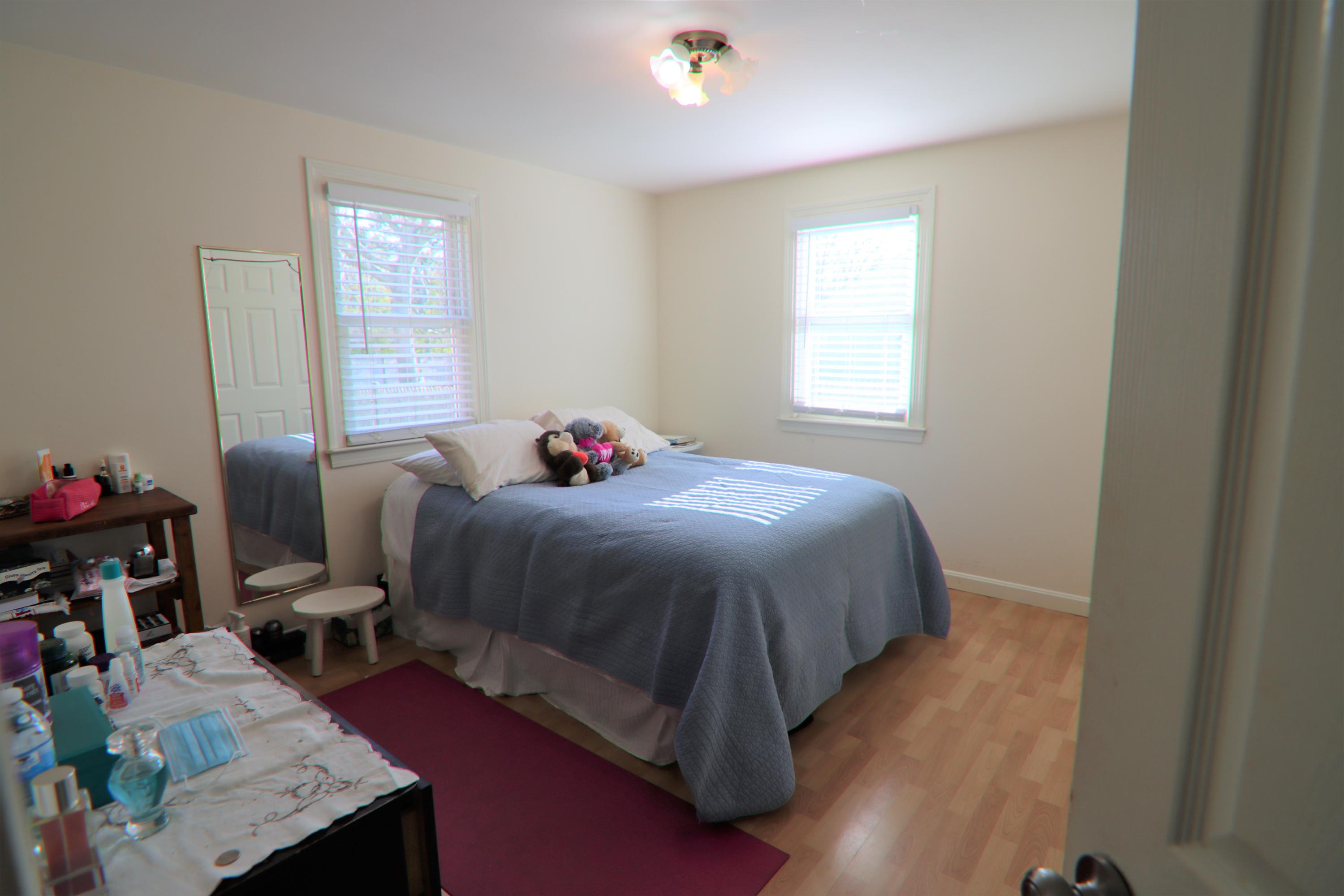 5 Alicia Road Hyannis, MA 02601 - Photo 8 of 12 a bedroom with a bed and wooden floor
