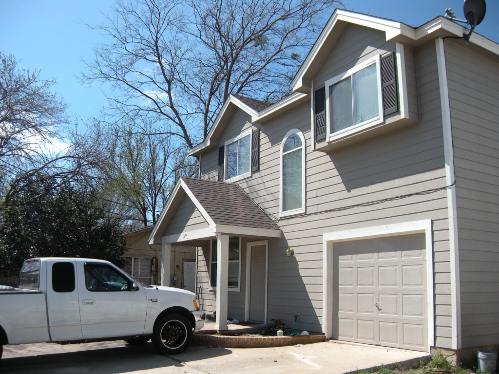 a house view with a car parked in front of it