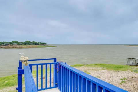 a view of swimming pool with a lake from a balcony