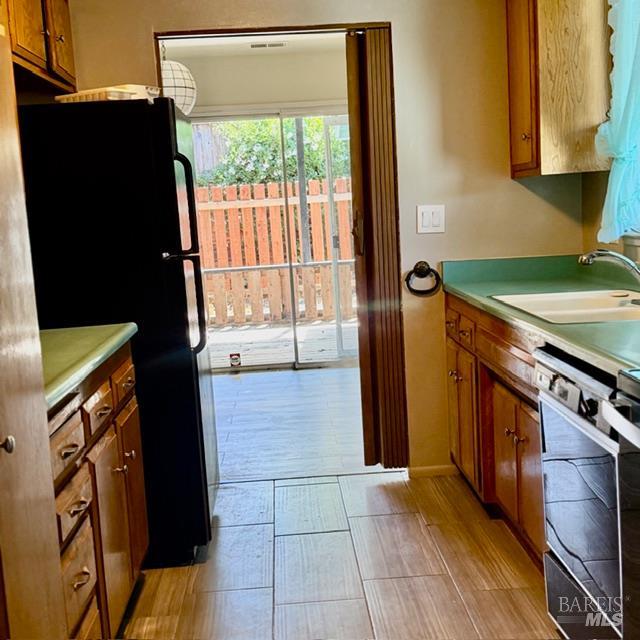 12 Glengreen Street Santa Rosa, CA 95409 - Photo 2 of 11 a kitchen with a stove a refrigerator and a sink