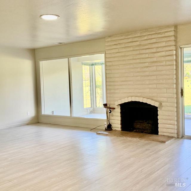 12 Glengreen Street Santa Rosa, CA 95409 - Photo 6 of 11 an empty room with a fireplace and window