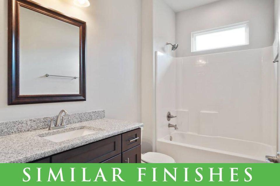 8543 Laredo Street Navarre, FL 32566 - Photo 13 of 14 a bathroom with a granite countertop sink a mirror and a bathtub
