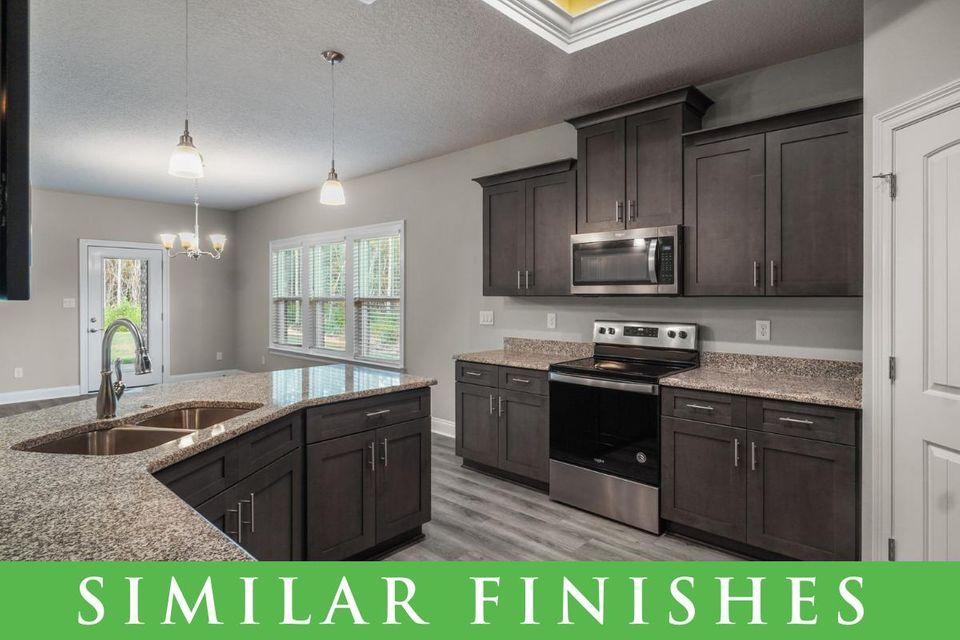 8543 Laredo Street Navarre, FL 32566 - Photo 3 of 14 a kitchen with kitchen island granite countertop a sink stainless steel appliances and cabinets