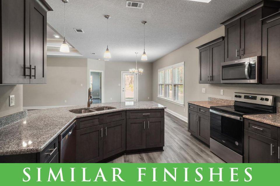 8543 Laredo Street Navarre, FL 32566 - Photo 5 of 14 a kitchen with stainless steel appliances granite countertop a sink a stove and cabinets