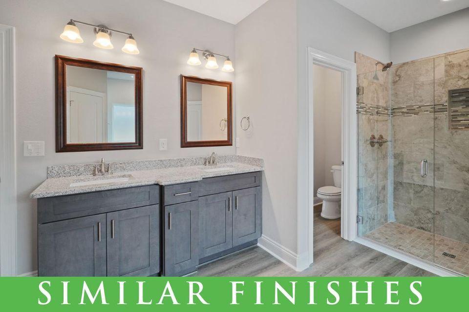 8543 Laredo Street Navarre, FL 32566 - Photo 9 of 14 a bathroom with a sink a toilet and shower