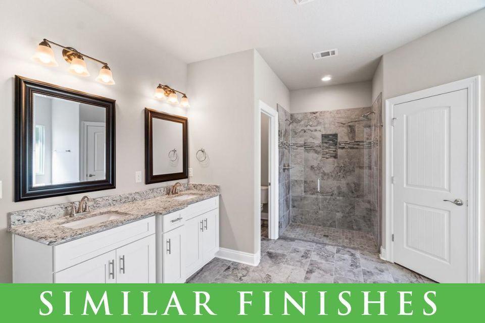 8543 Laredo Street Navarre, FL 32566 - Photo 10 of 14 a bathroom with a granite countertop sink and a mirror